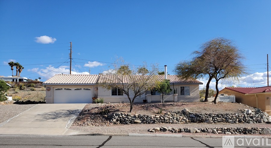 A house with a garage and a driveway in front of it.
