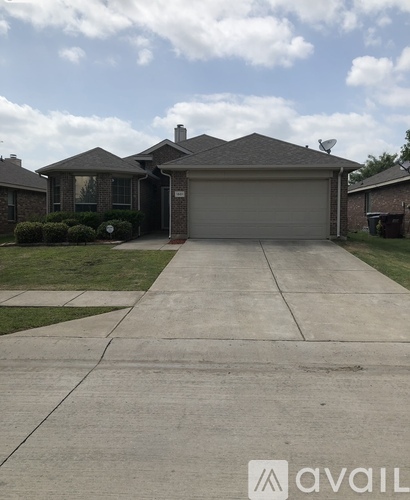 A house with a grey garage door and a driveway in front.