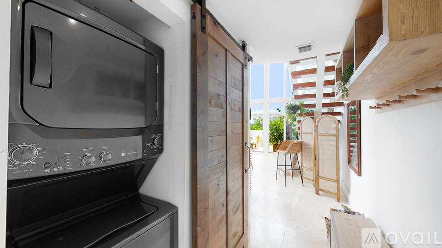 A modern kitchen with a black oven and microwave.