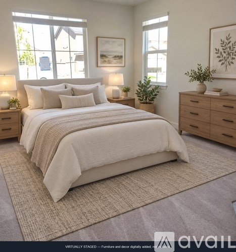 A bedroom with a large bed, two nightstands, and a plant.