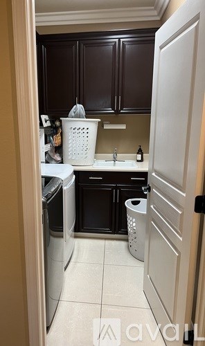 A kitchen with brown cabinets and a white door.