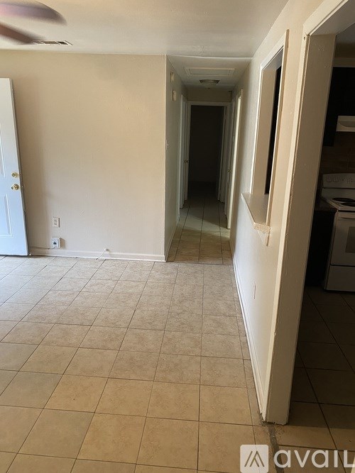 A room with a tiled floor and a ceiling fan.