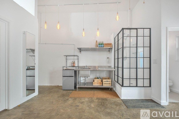 A kitchen area with a glass cabinet and a countertop with a sink.