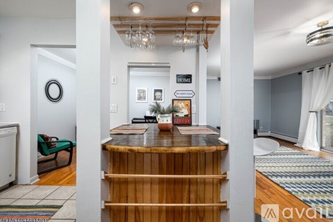 A wooden staircase leads to a living room with a couch and a coffee table.