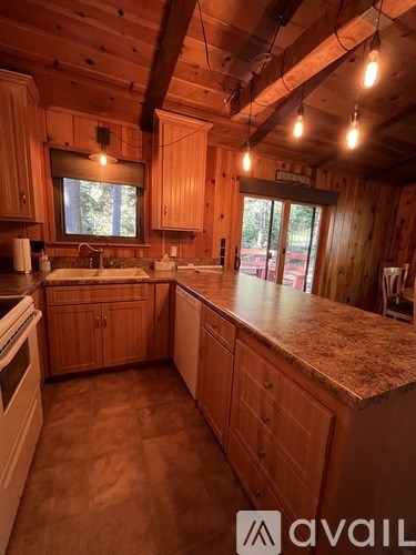 A kitchen with wooden cabinets and a granite countertop.