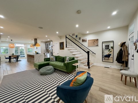 A living room with a striped rug and a blue armchair.