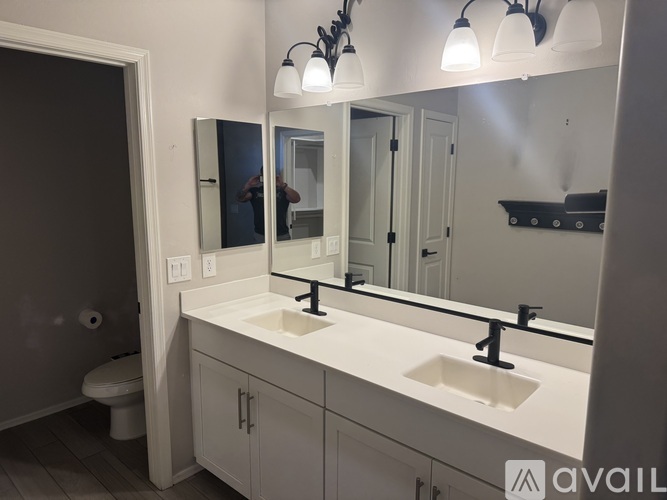 A bathroom with a white sink and a mirror above it.
