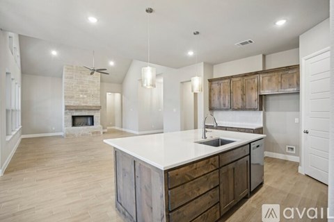 A spacious kitchen with wooden cabinets and a white countertop.