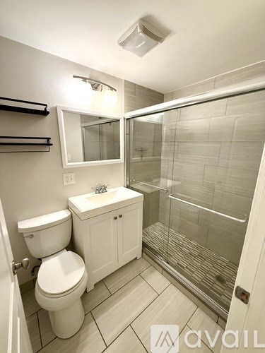 A room with a brown chair and a brown rug.