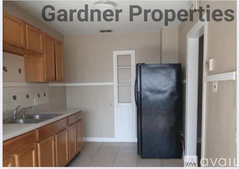 A kitchen with Gardner Properties written on the wall.
