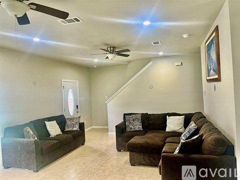 A living room with two couches and a staircase.