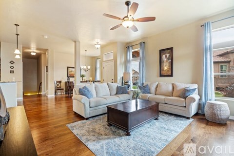 A living room with a white couch and a coffee table.