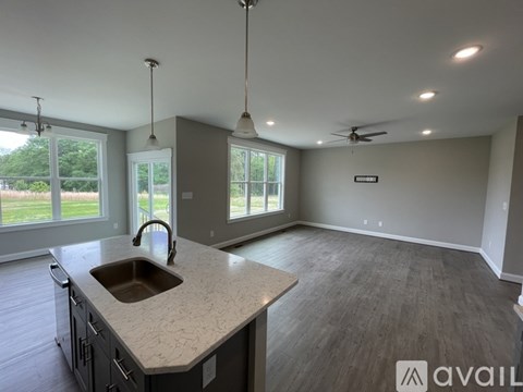 A kitchen with a sink and a window.