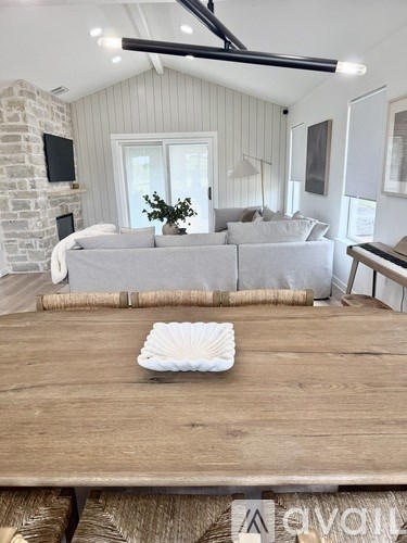 A living room with a grey couch and a wooden table.