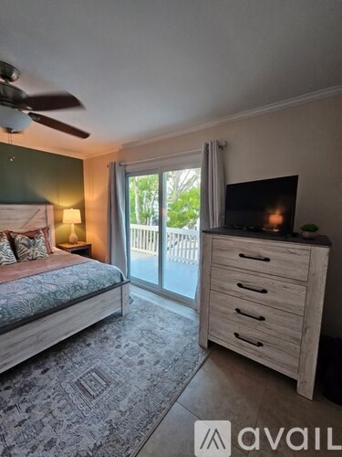 A bedroom with a bed, nightstand, and lamp.