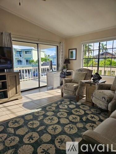 A living room with a fan and sliding glass doors.