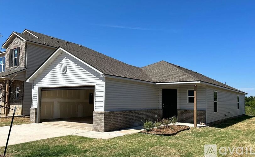 A two-story house with a garage is available for sale.