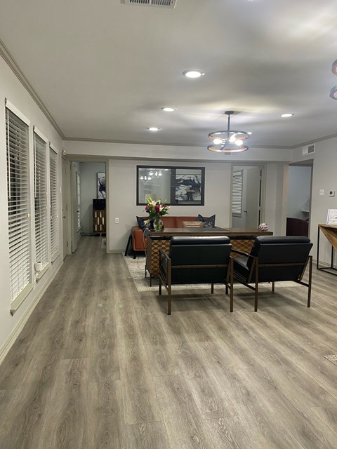 A dining room with a table and chairs.