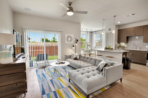 A modern living room with a white sofa and a wooden coffee table.