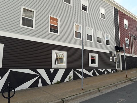 A building with a black and white design on the side.