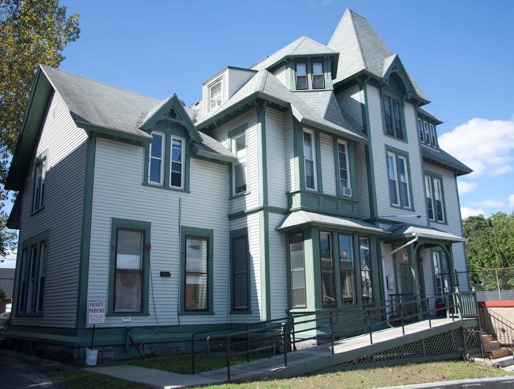 A large house with a grey and green exterior.