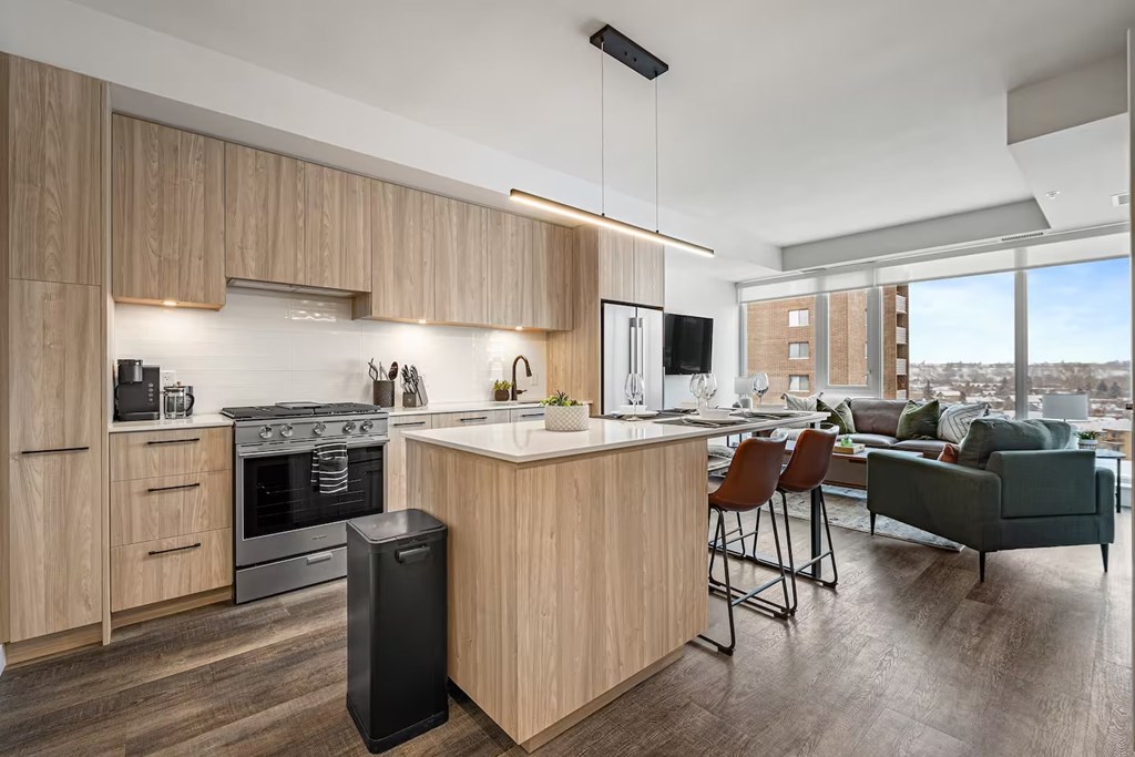 A modern kitchen with wooden cabinets and a large island.