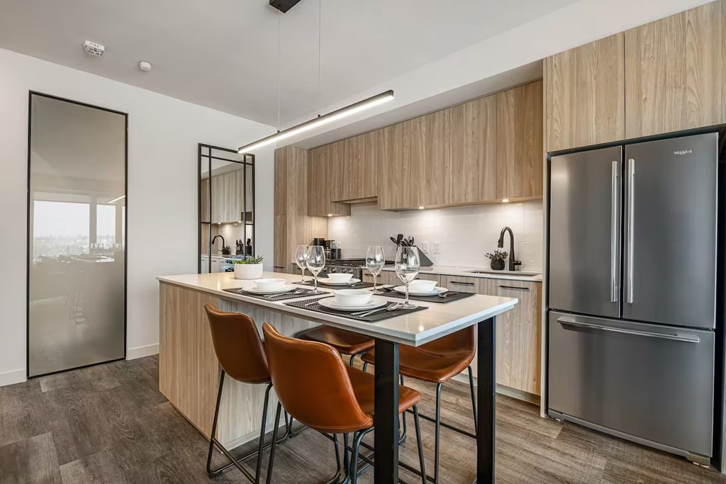 A modern kitchen with a table and chairs.