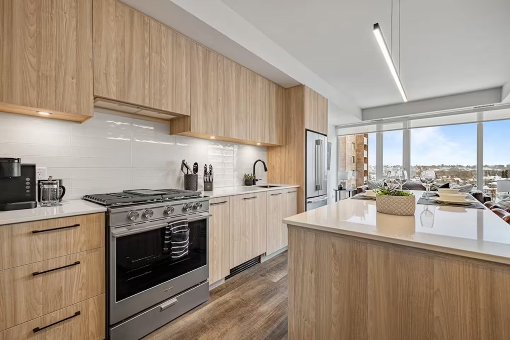 A modern kitchen with wooden cabinets and stainless steel appliances.