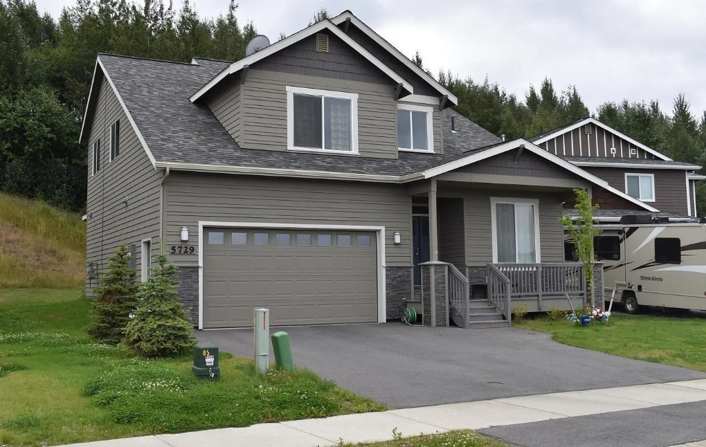 A house with a grey exterior and a garage door.