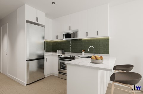 A modern kitchen with a stainless steel refrigerator, a microwave, a stove, and a sink.