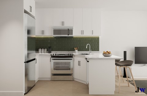 A modern kitchen with white cabinets and a stainless steel refrigerator.