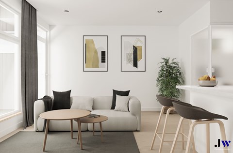 A modern living room with a white sofa, a round table, and two chairs.