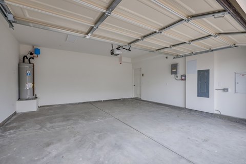 A spacious garage with a concrete floor and white walls.
