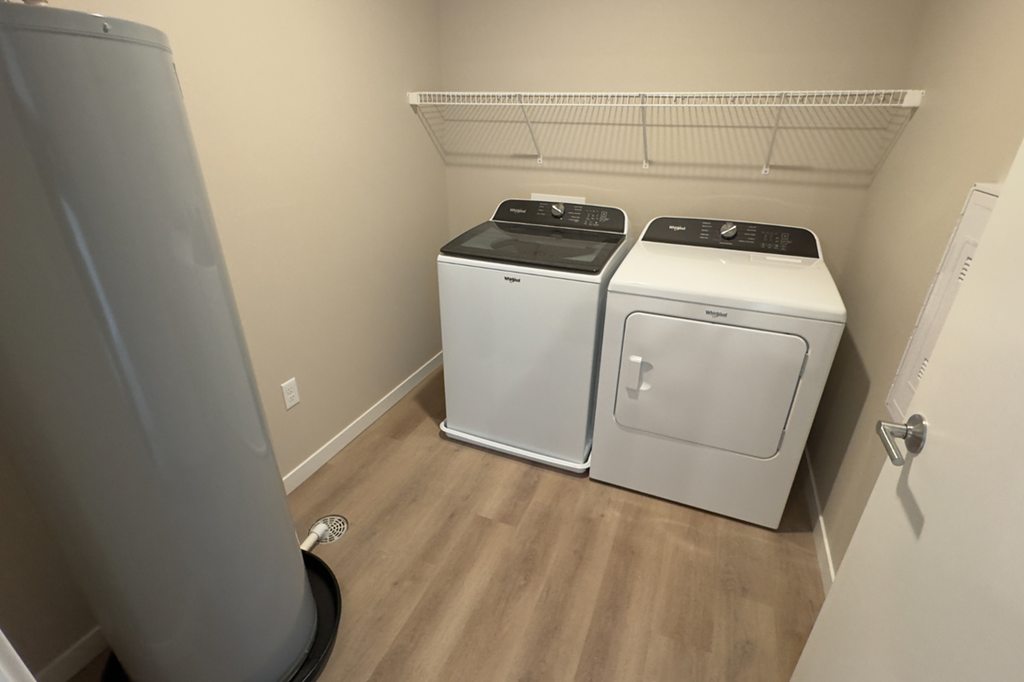 A small laundry room with a washer and dryer.