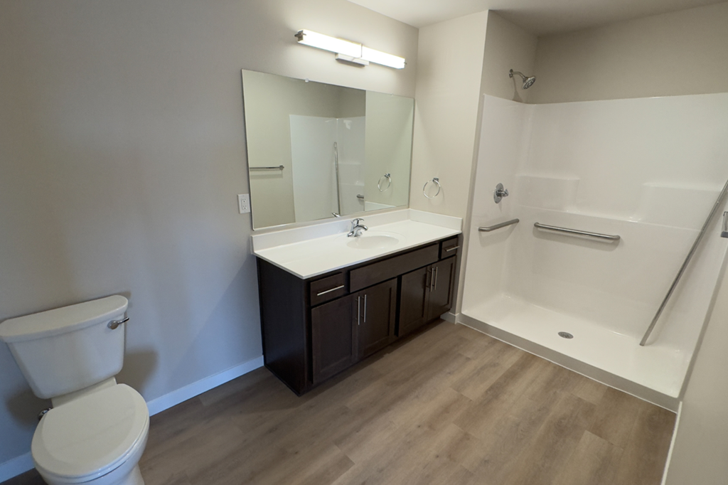 A white toilet sits next to a sink in a bathroom.
