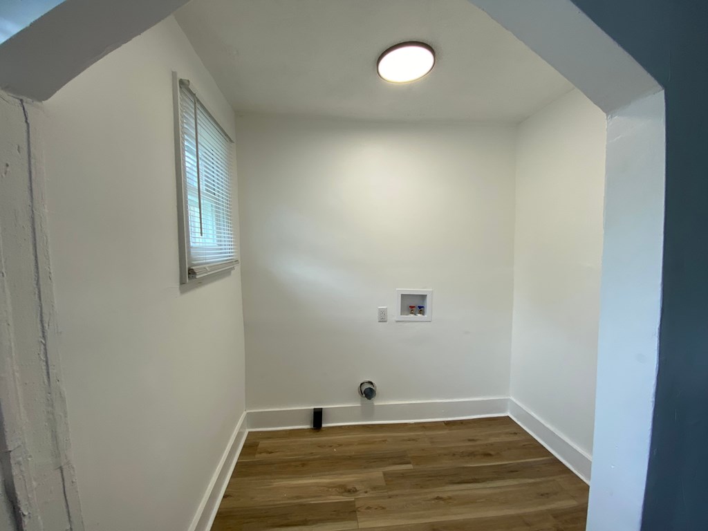 A room with a window and a light on the ceiling.