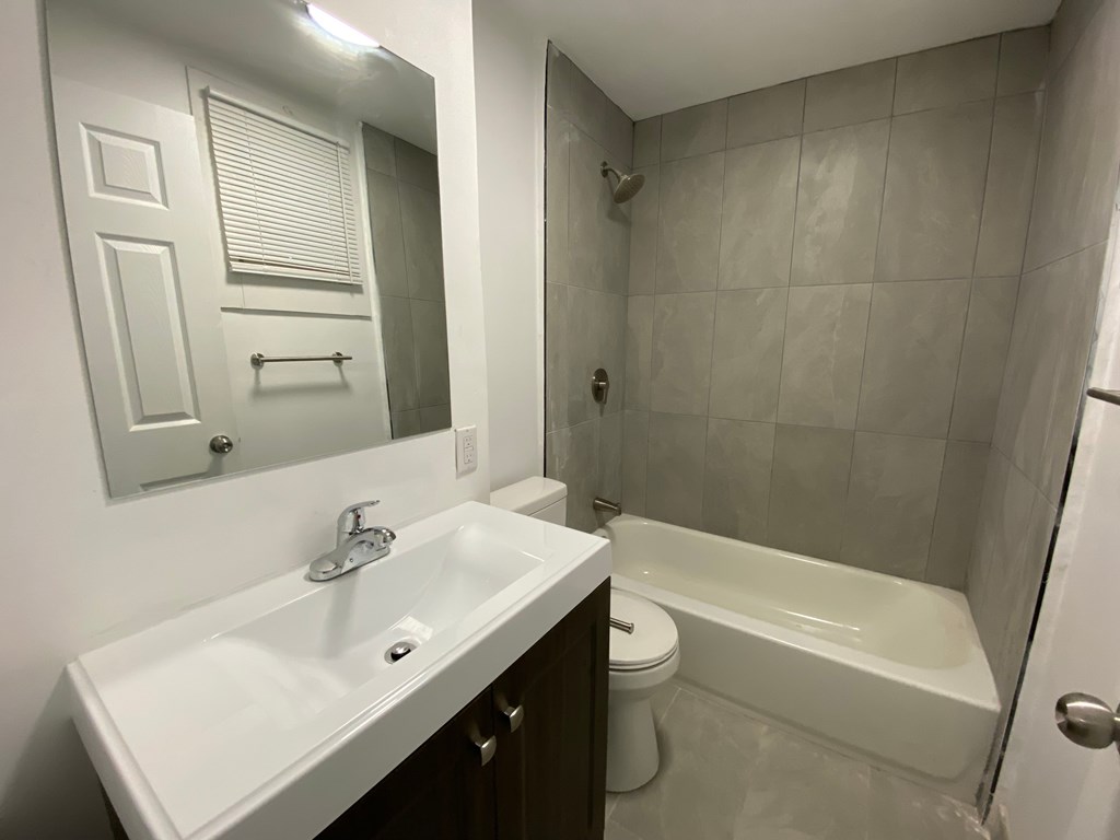 A white sink with a mirror above it.