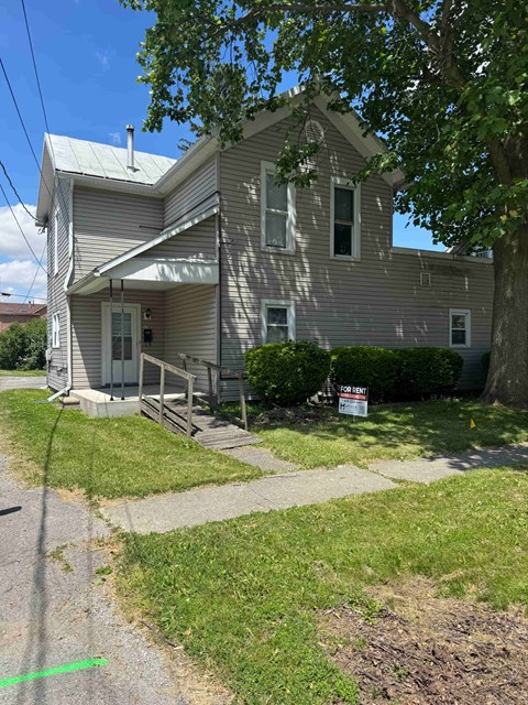 A house with a grey facade is for sale.