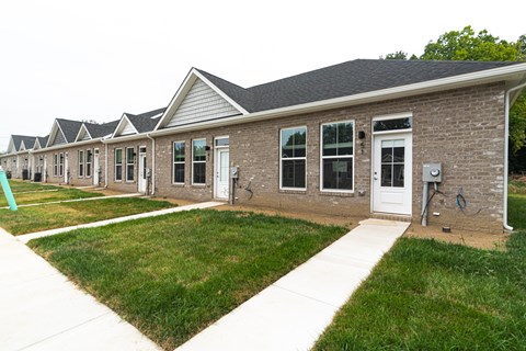 A series of houses with similar design and brick walls.