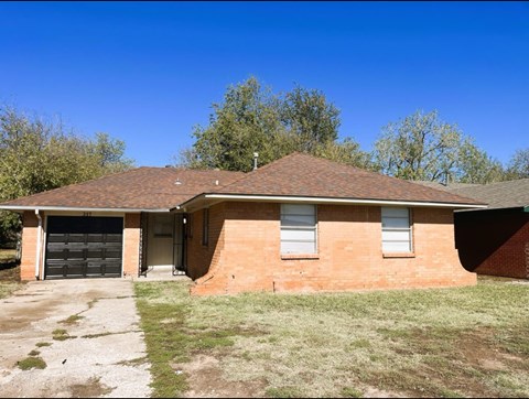 A house with a garage and a driveway.