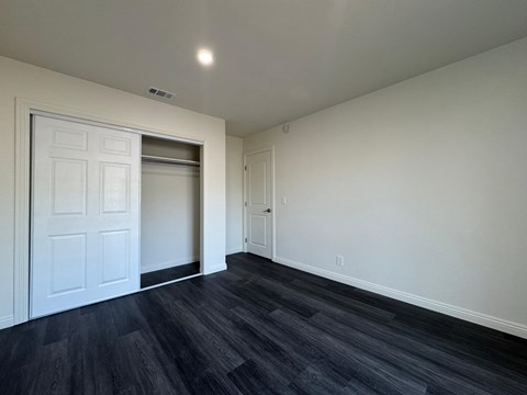 A room with a white door and a black floor.