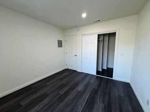 A room with a white door and a grey door.