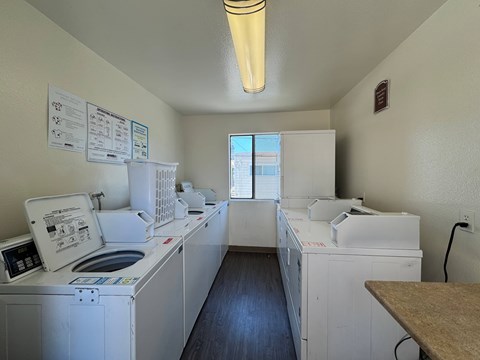 A laundry room with washers and dryers.