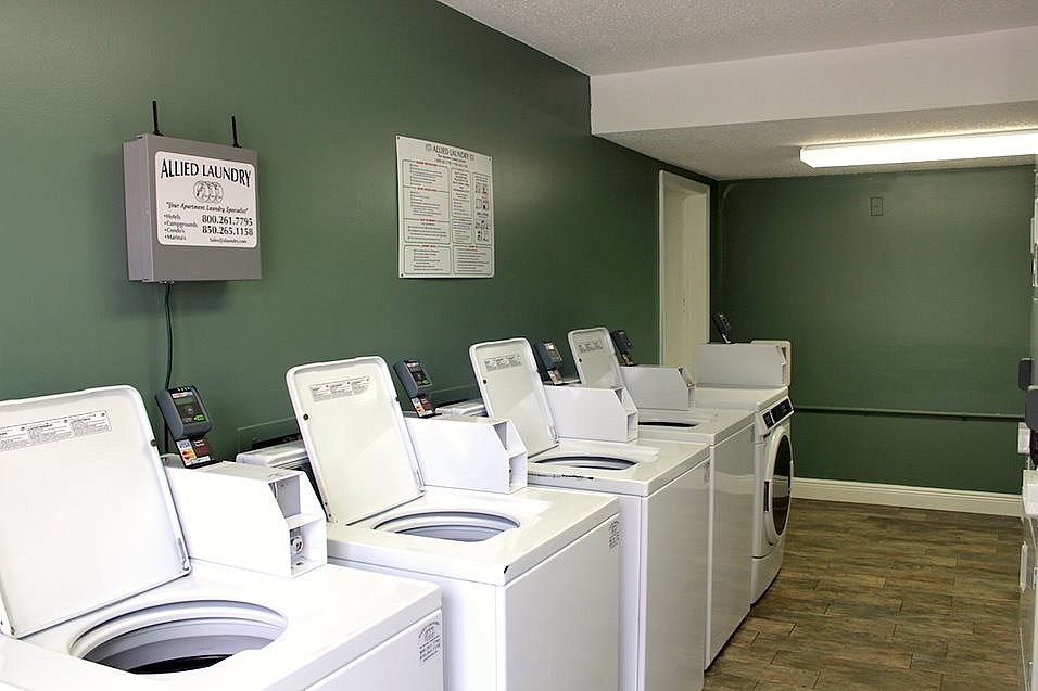 A row of washing machines in a laundromat.