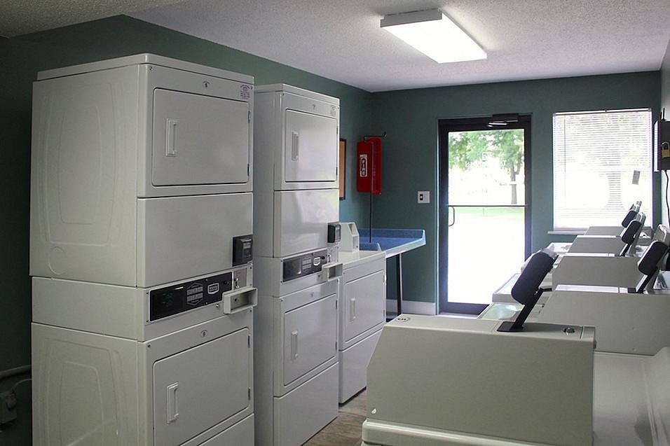 A laundry room with washers and dryers.