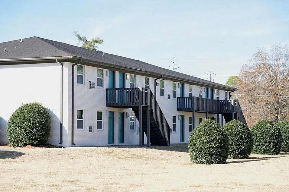 A two-story house with a balcony and a balcony railing.