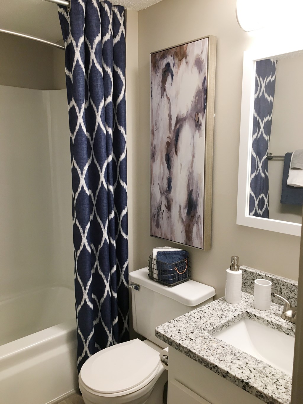 A bathroom with a toilet, sink, and a shower curtain.