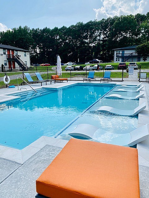A pool with a bench in front of it.