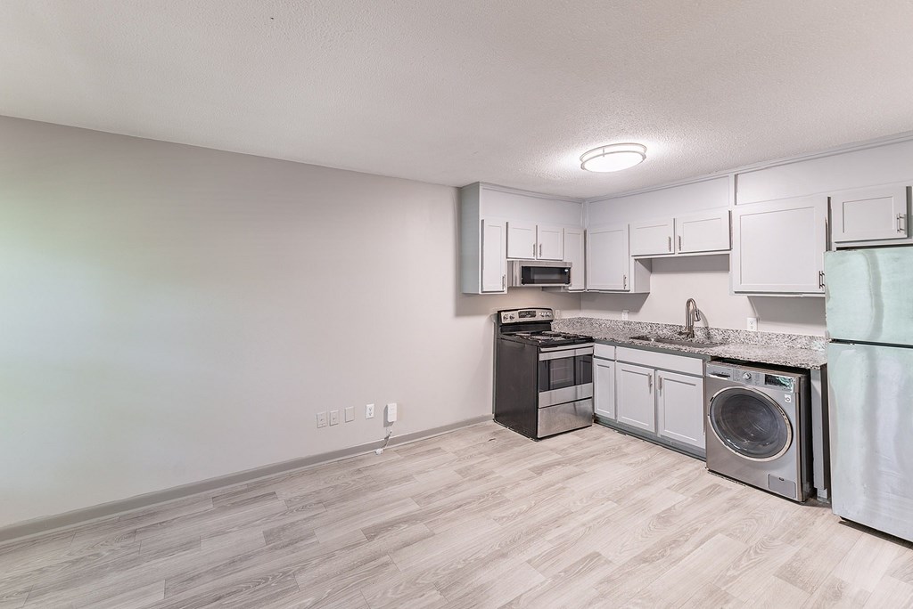 A kitchen with a washing machine and a dishwasher.