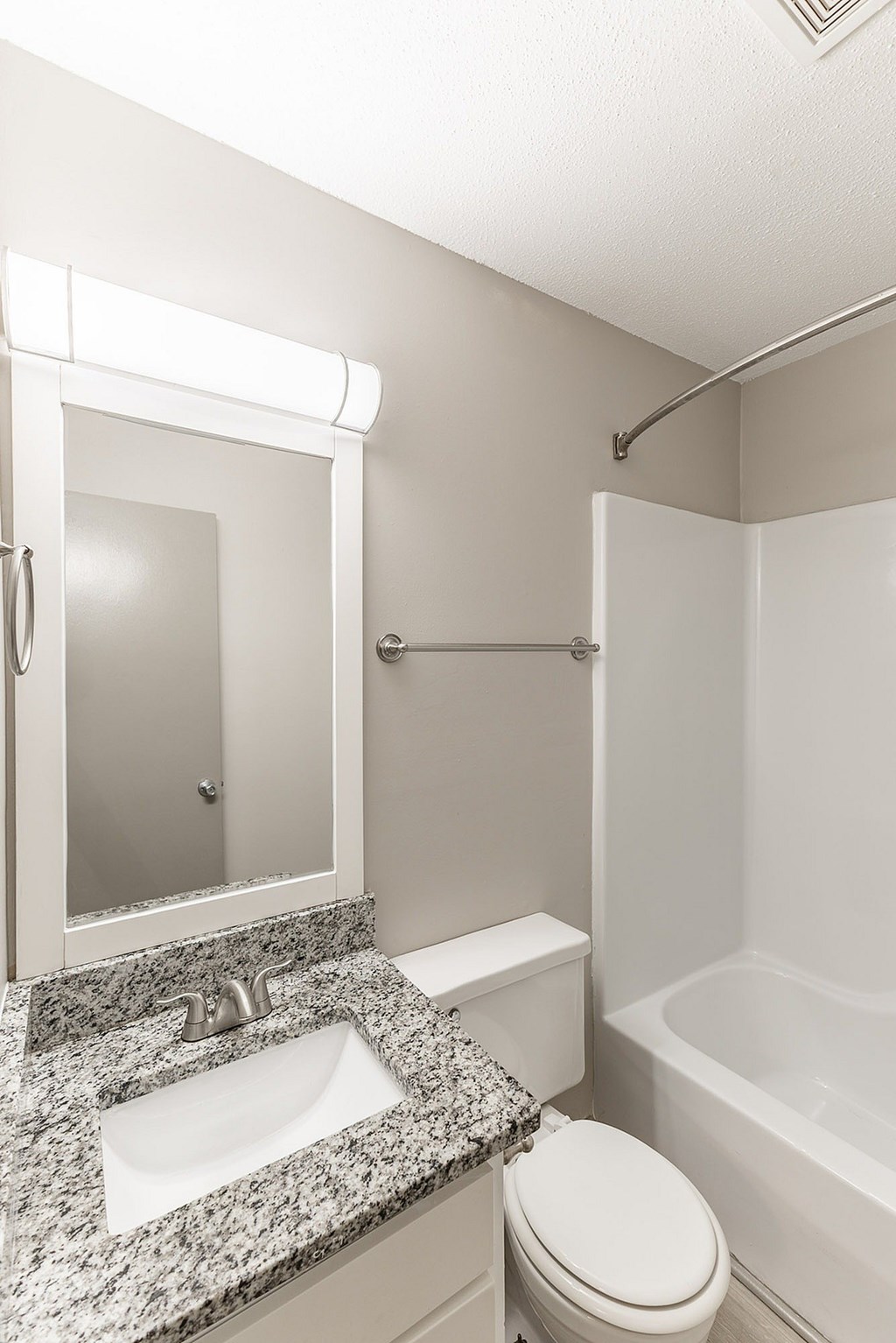 A white toilet sits next to a sink in a bathroom.